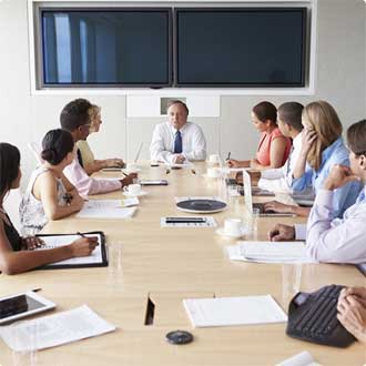 people sitting around meeting table