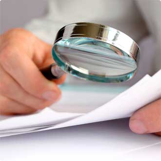 person reading with magnifying glass